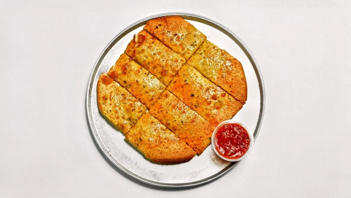 Fresh pizza preparation at Pizza 64 Winnipeg